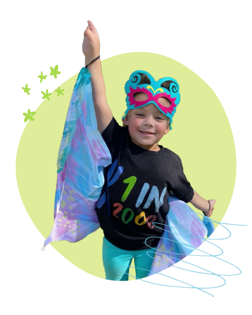 Photo of a little girl smiling and wearing a black "1 in 2,000" shirt while extending shimmering cloth butterfly wings.
